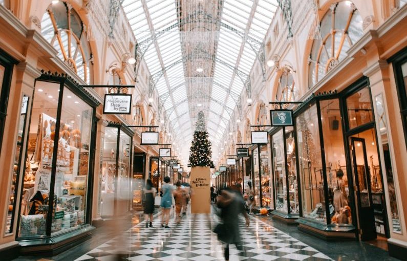 Shopping - person walking inside building near glass