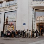 Luxury Shopping - people queuing beside Louis Vuitton store