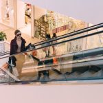 Luxury Shopping - woman riding escalator
