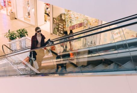 Luxury Shopping - woman riding escalator