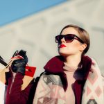 Luxury Shopping - shallow focus photography of woman holding shopping bags during day