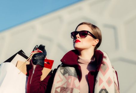 Luxury Shopping - shallow focus photography of woman holding shopping bags during day