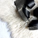 Styled Shoes - pair of women's black-and-gray wedges on white fur textile