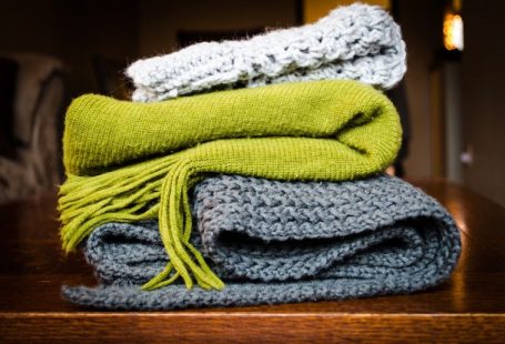 Scarves - three gray, green, and white scarf on top of table