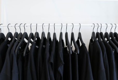 Minimalism Fashion - black clothes hanged in rack