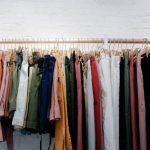 Clothes - assorted-color clothes lot hanging on wooden wall rack