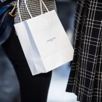 Luxury Shopping - white paper bag on blue and white textile