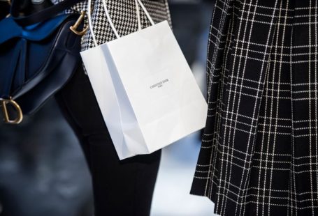 Luxury Shopping - white paper bag on blue and white textile