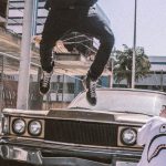 Streetwear - Man Jumping on Front of Brown Car
