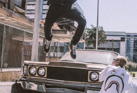 Streetwear - Man Jumping on Front of Brown Car