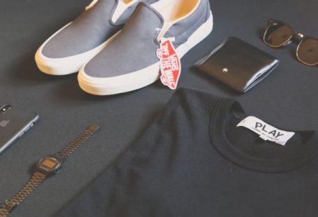 Brands - Pair of Gray Vans Low-top Sneakers Beside Black Shirt, Sunglasses, and Watch