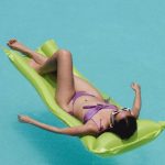 Beachwear - Relaxed woman lying on air mattress