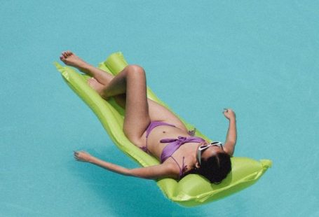 Beachwear - Relaxed woman lying on air mattress