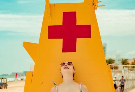 Sunglasses - Shallow Focus Photo of Woman Standing Near Lifeguard Tower
