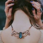 Necklace - Woman Wears Gold-colored Blue Gemstone Pendant Necklace