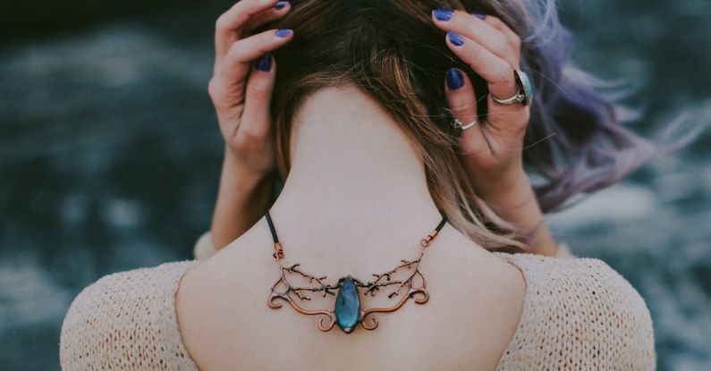 Necklace - Woman Wears Gold-colored Blue Gemstone Pendant Necklace