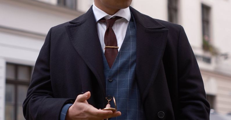 Tie Clip - A man in a suit and tie is standing on a street