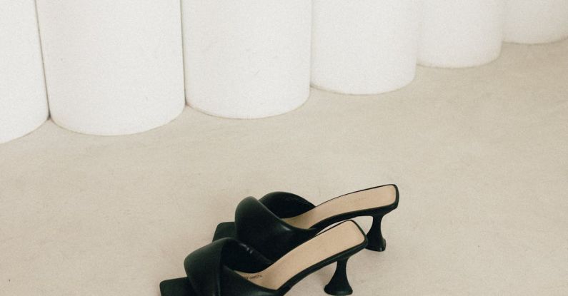 Vegan Shoes - A pair of black heels on a white surface